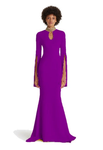 Woman wearing a purple evening gown with long sleeves on a white background