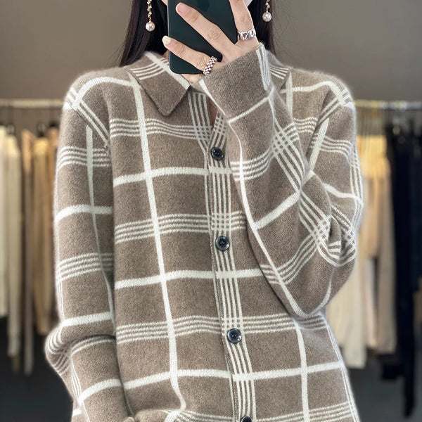 Plaid cardigan worn by a person with blurred clothing rack in the background