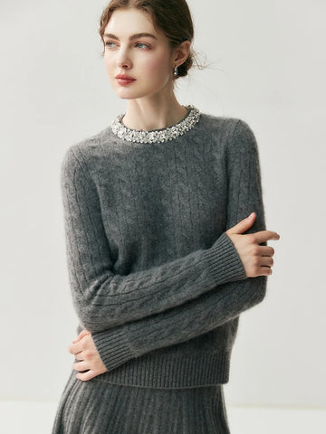 Woman wearing a gray sweater with a white background