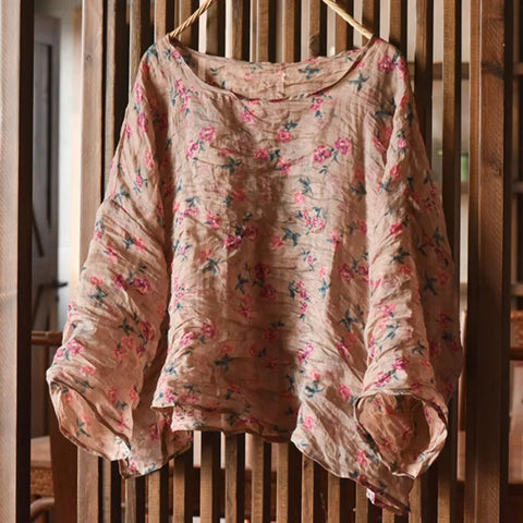 Floral-patterned shirt hanging on a wooden rack