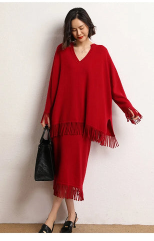 Woman wearing a red fringed dress against a white background